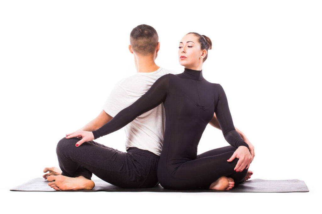 concept couple yoga young healthy couple yoga position white background Couples Yoga